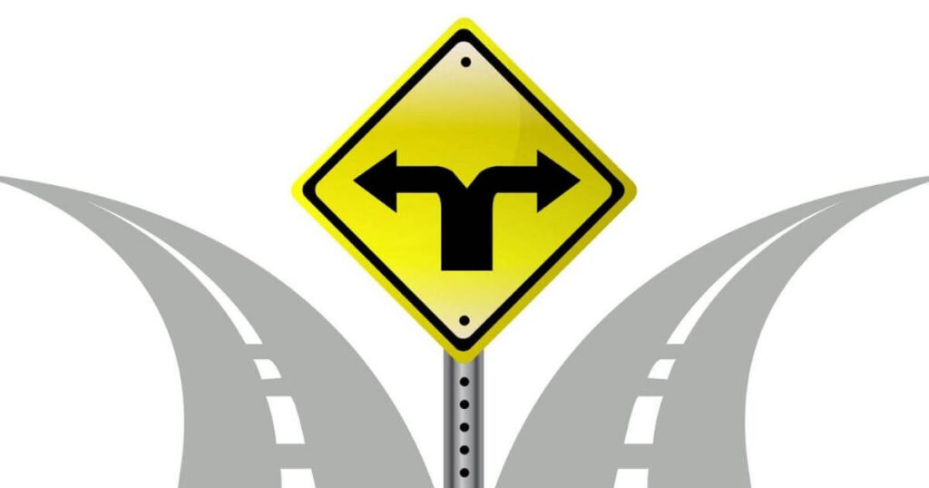 yellow traffic sign with two arrows, each arrow points to a different road