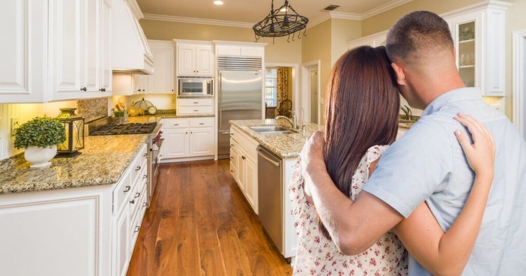 couple arm in arm in kitchen
