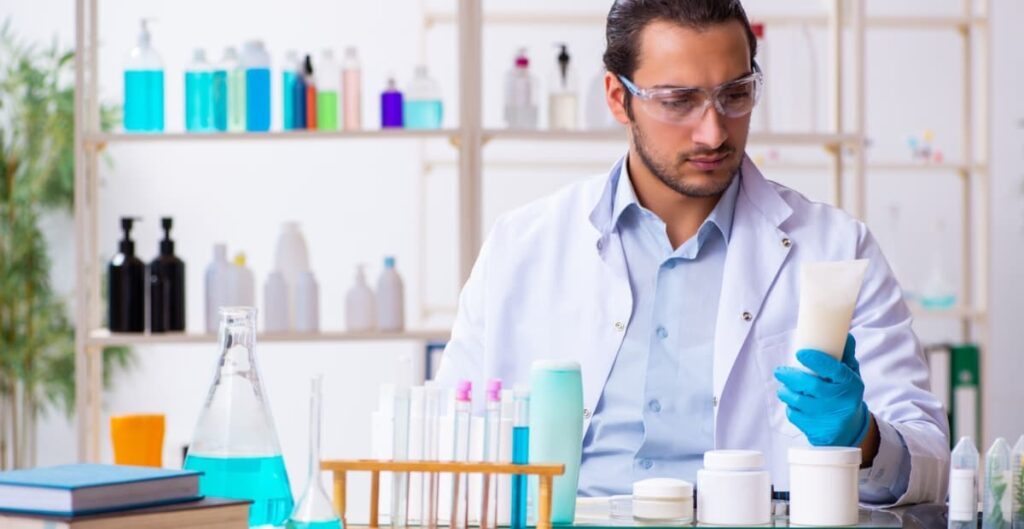 male chemist creating fragrance chemicals in the lab