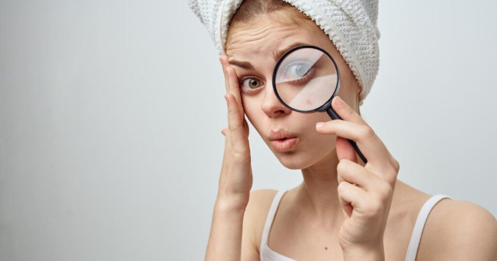 shocked woman looking through magnifying glass