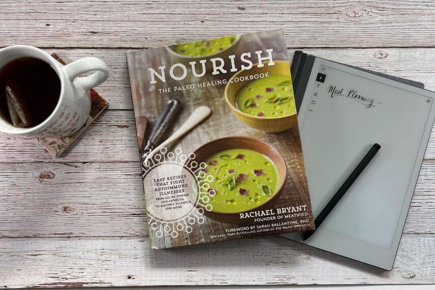Nourish cookbook, digital notebook, digital pencil, and cup of tea