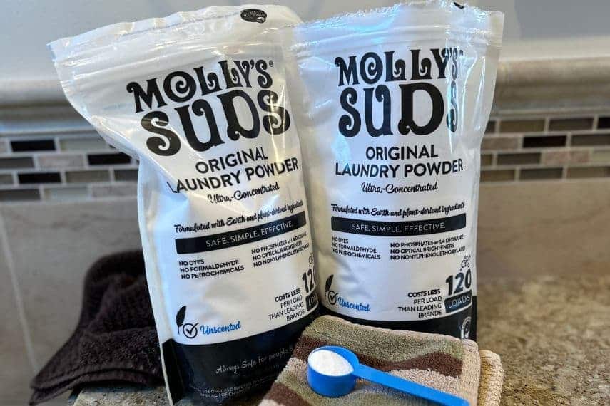 Molly's Suds-2 bags, scoop with owder, on washcloths