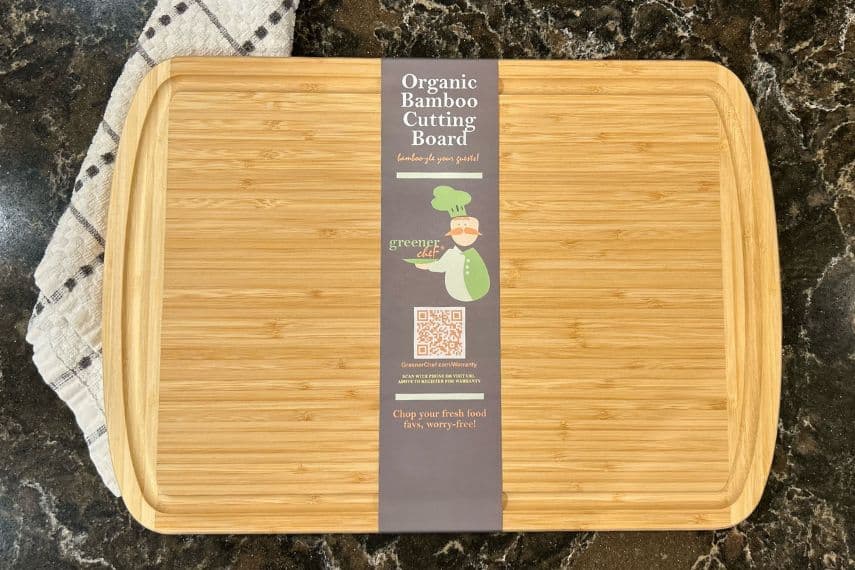 organic bamboo cutting board on counter with towel in background