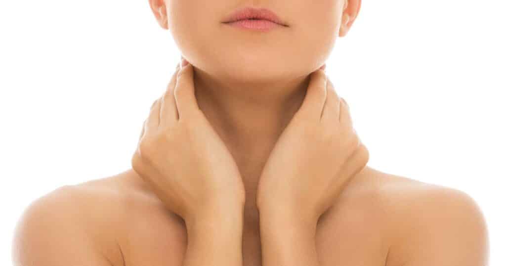 partial image of woman with hands on her neck